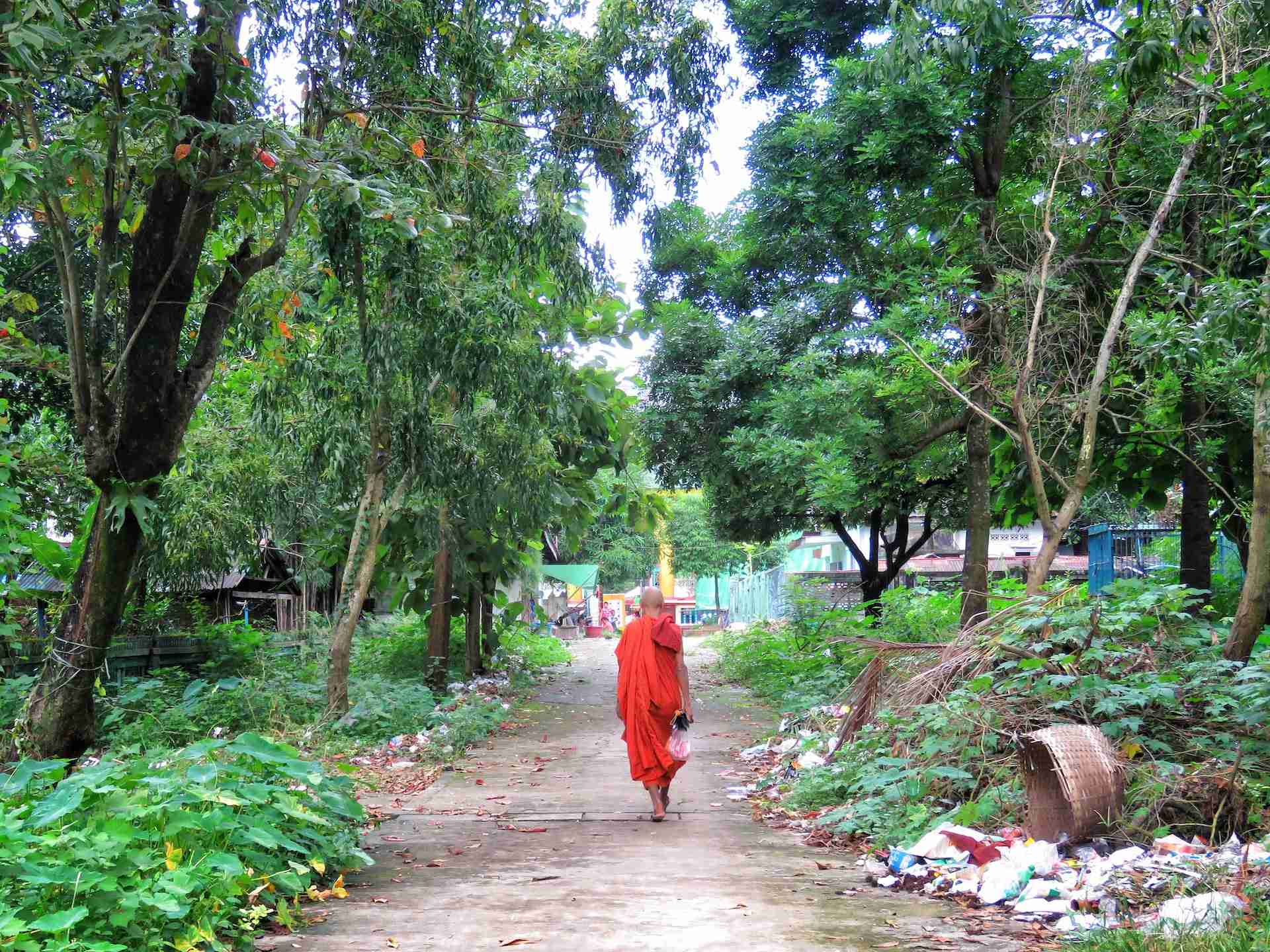 man in monk suit walking on road during daytime
