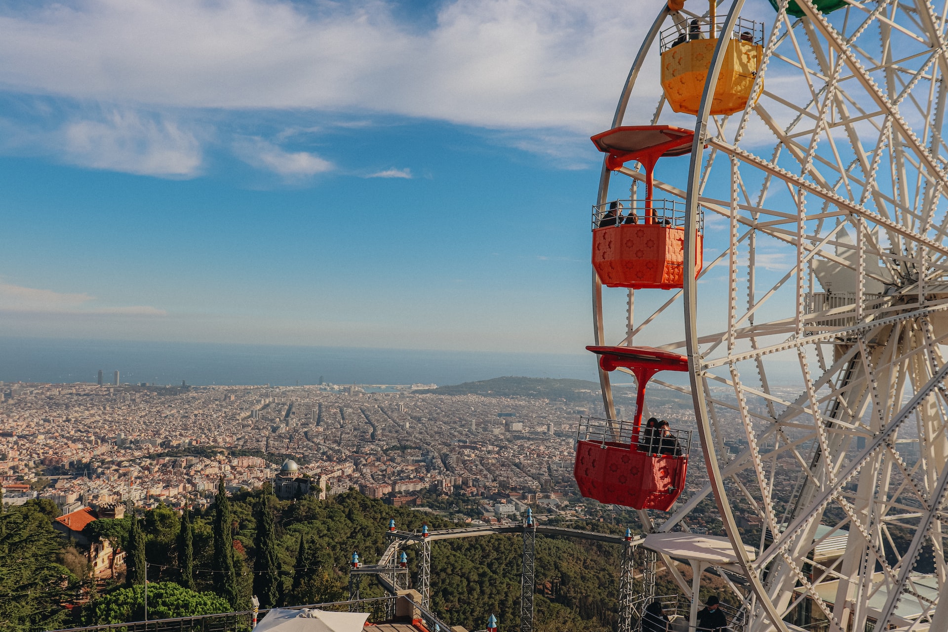 a ferris wheel overlooking the city of barcelona