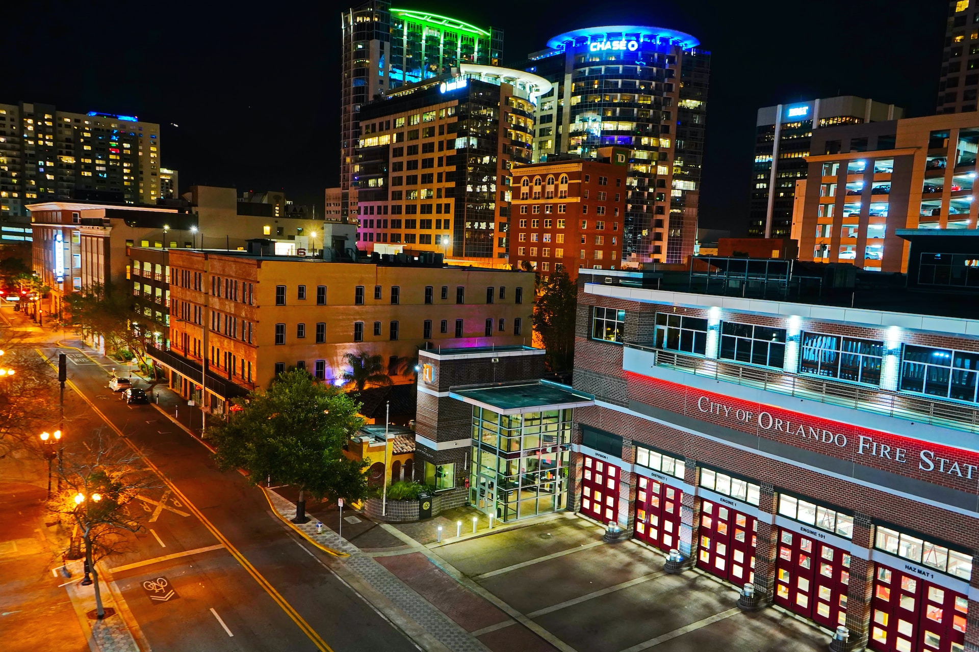 a city street at night with buildings lit up