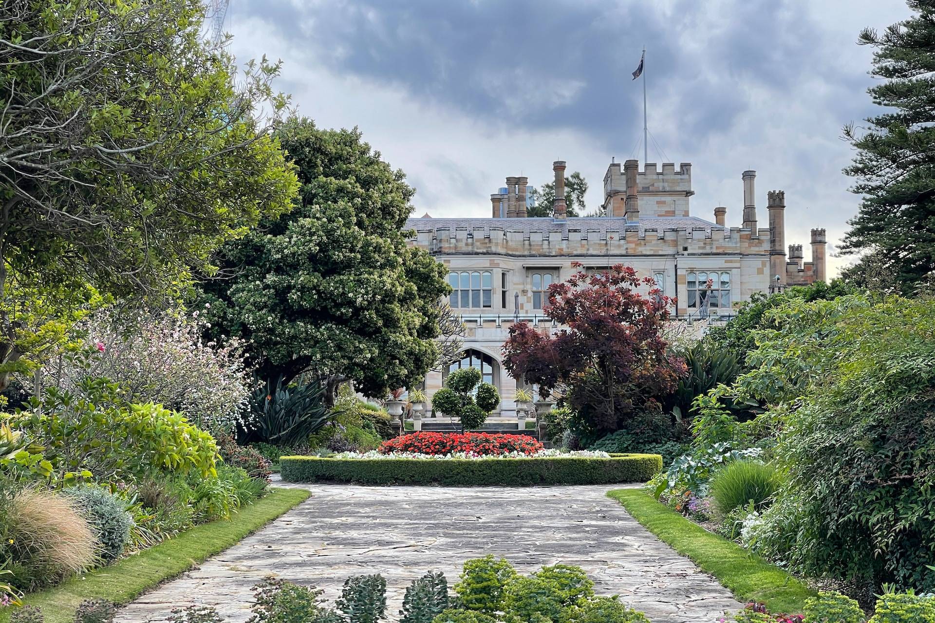 a large building surrounded by trees and flowers