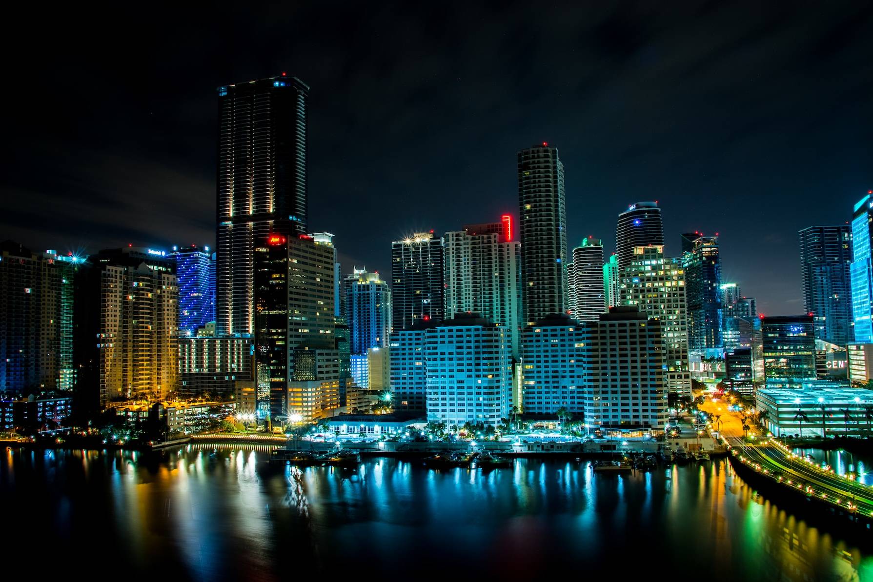 lighted building near body of water at nighttime