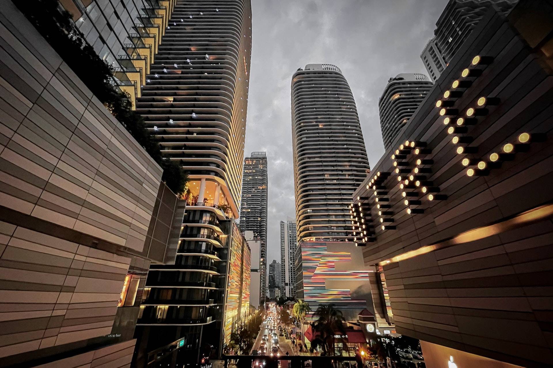 people walking on street near high rise buildings during night time