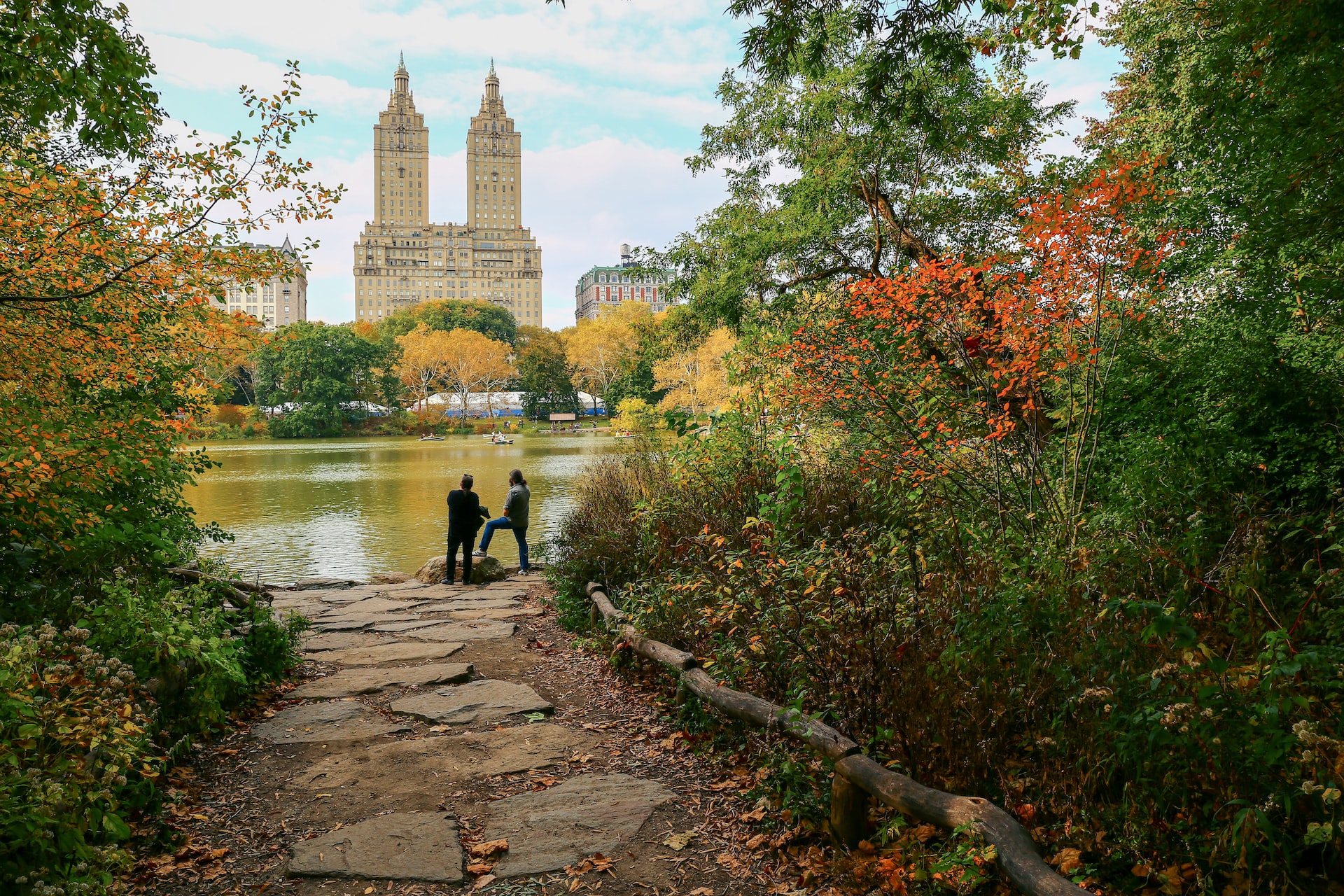 people walking on pathway near body of water during daytime