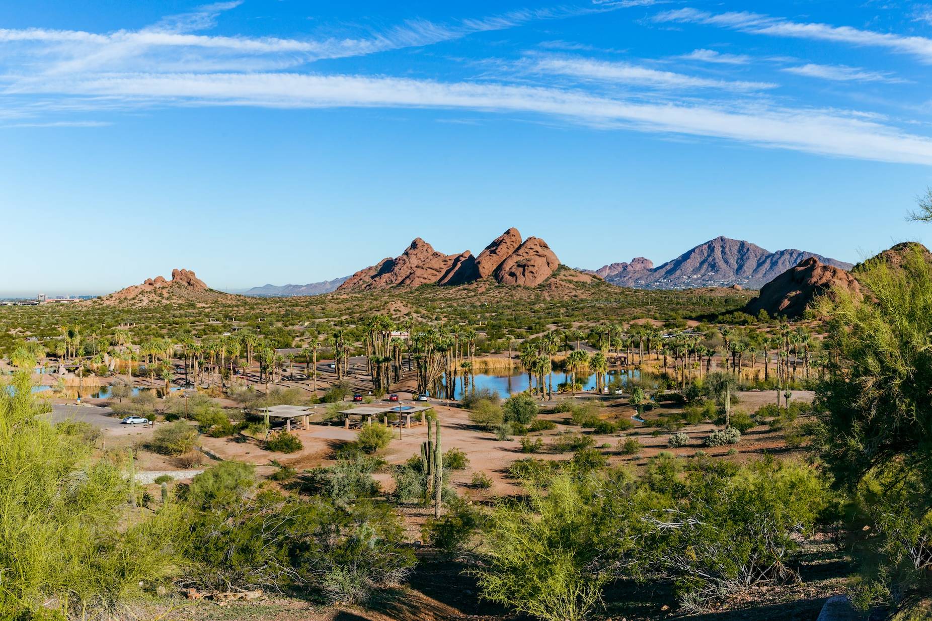 a scenic view of a desert with mountains in the background