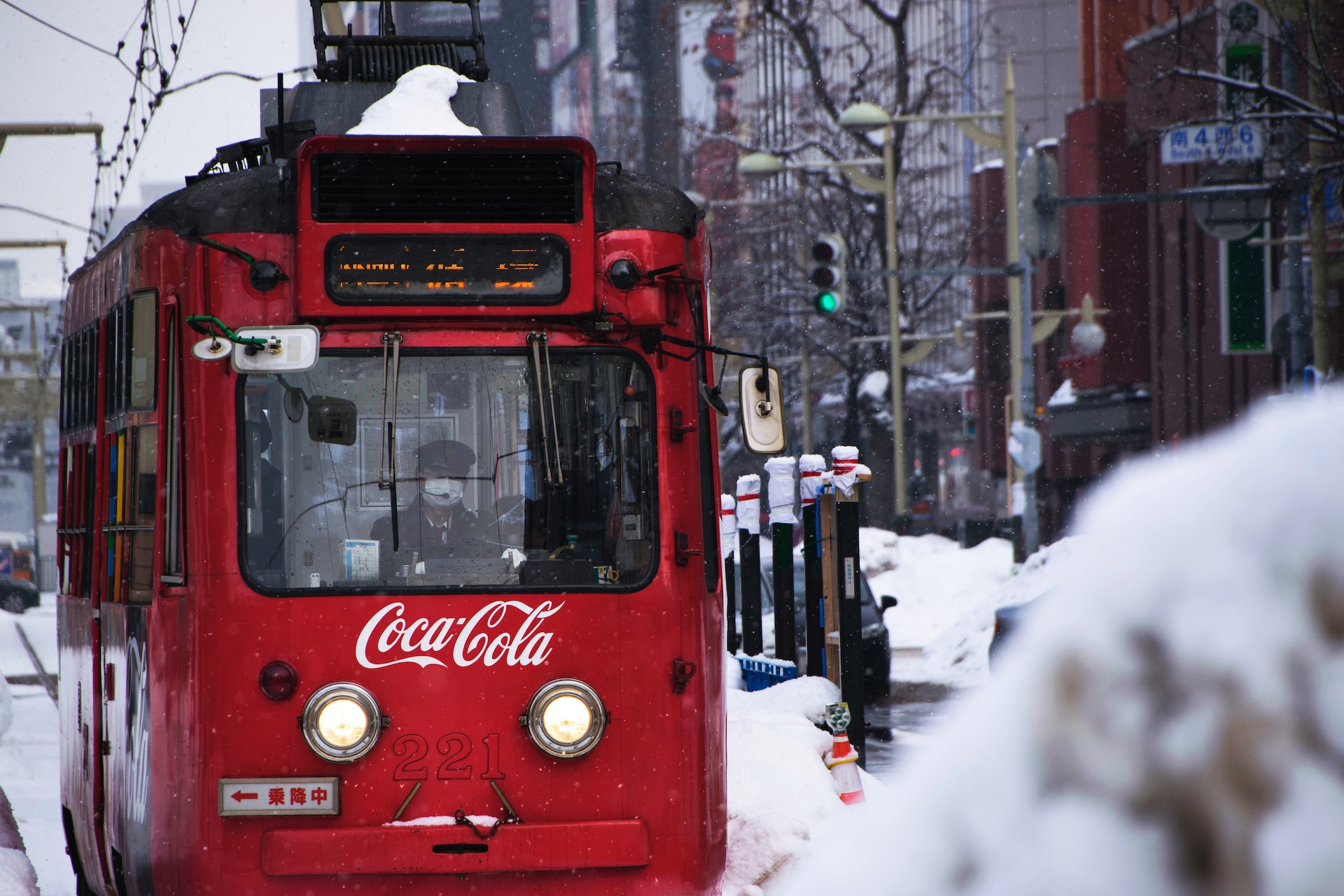 red Coca-Cola tram during snow