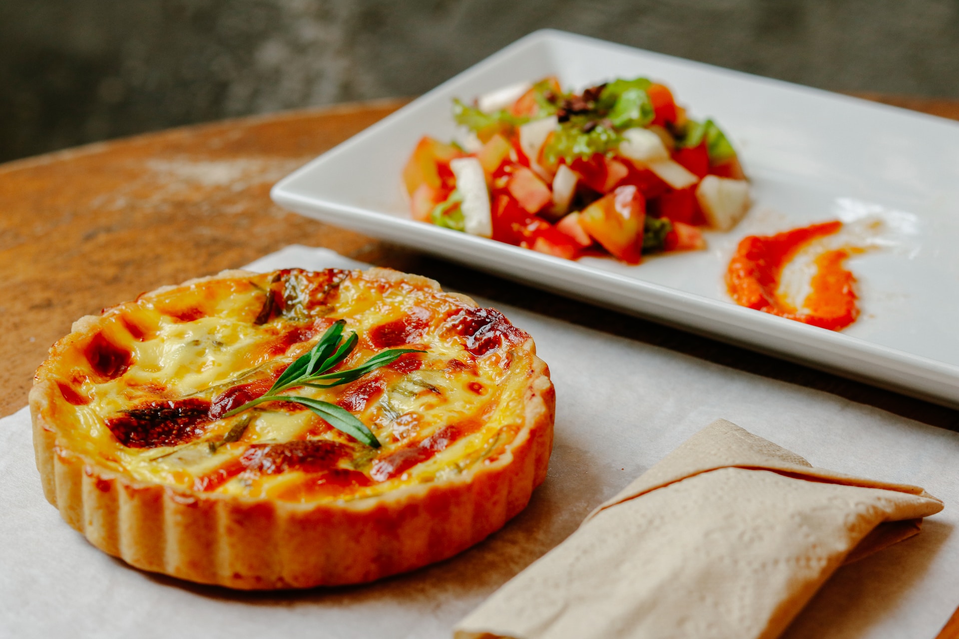 pizza with green leaf on white ceramic tray