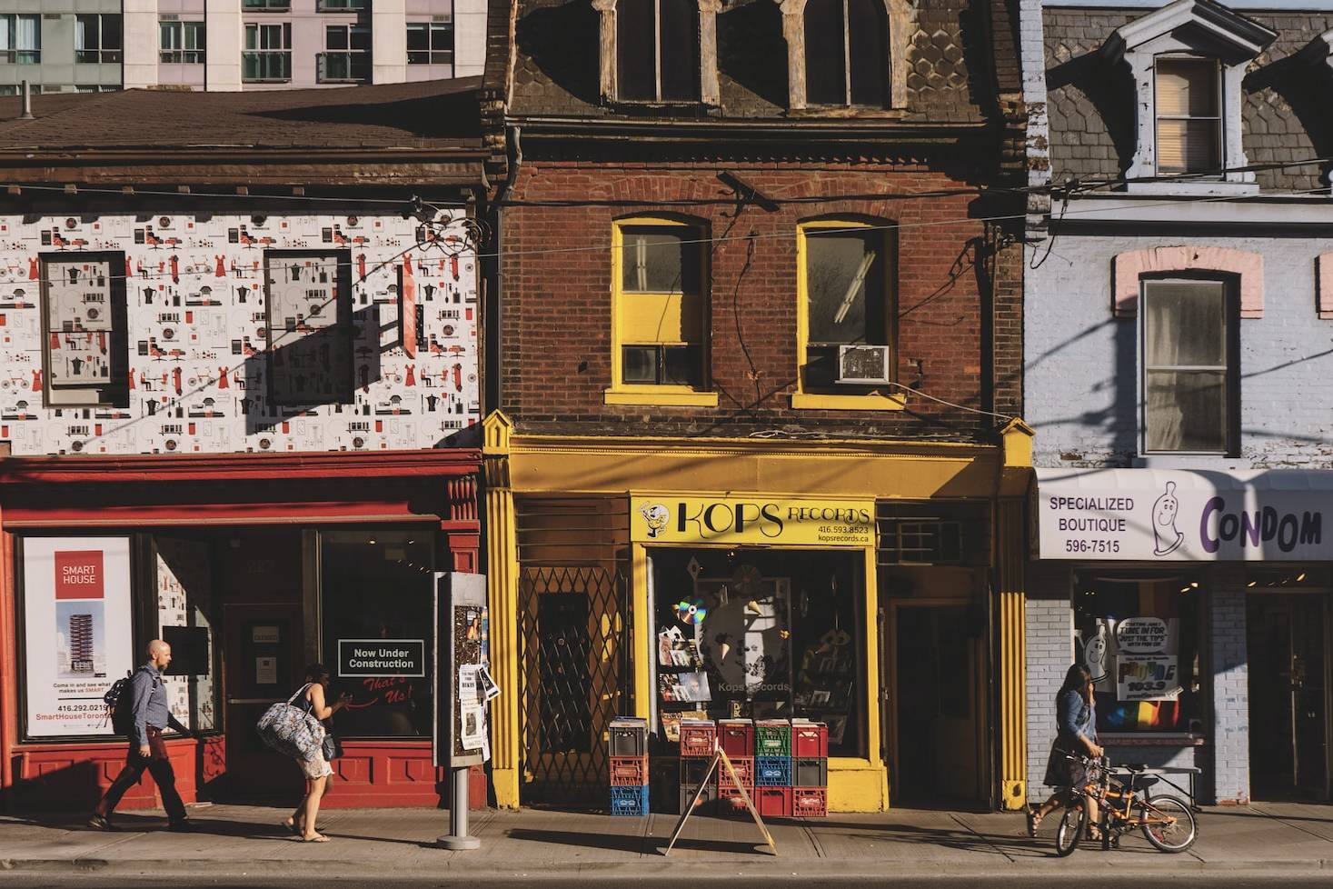 woman standing in front of red store during daytime