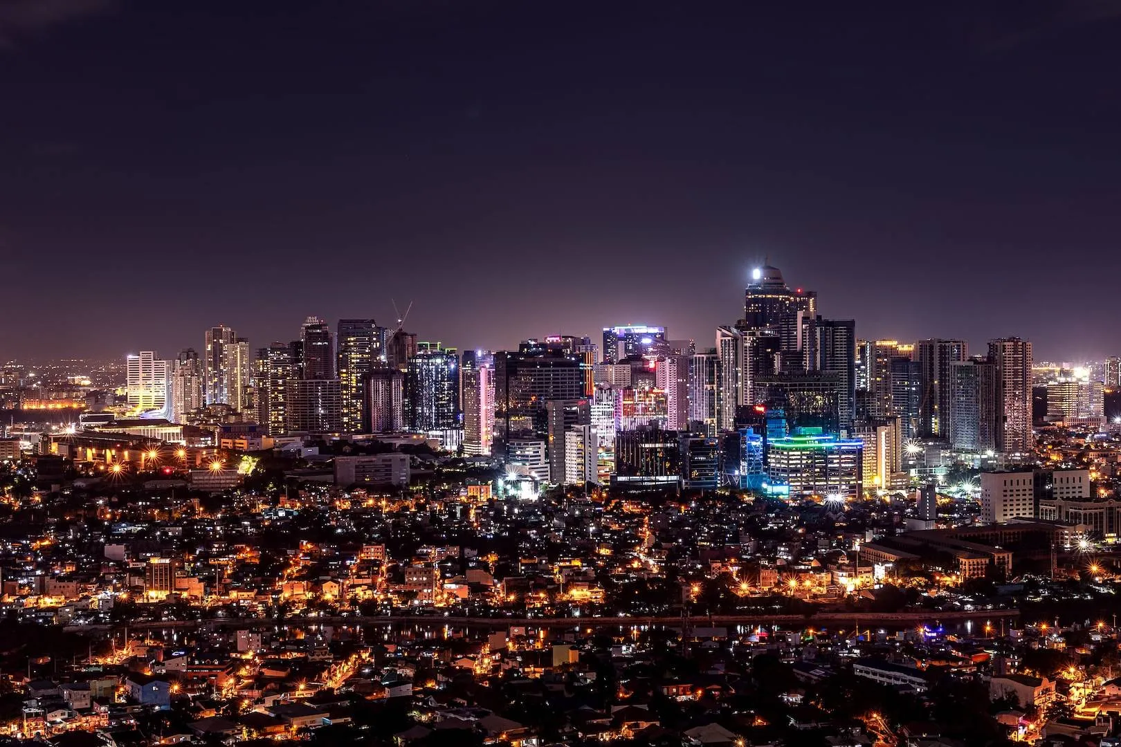 city with high rise buildings during night time