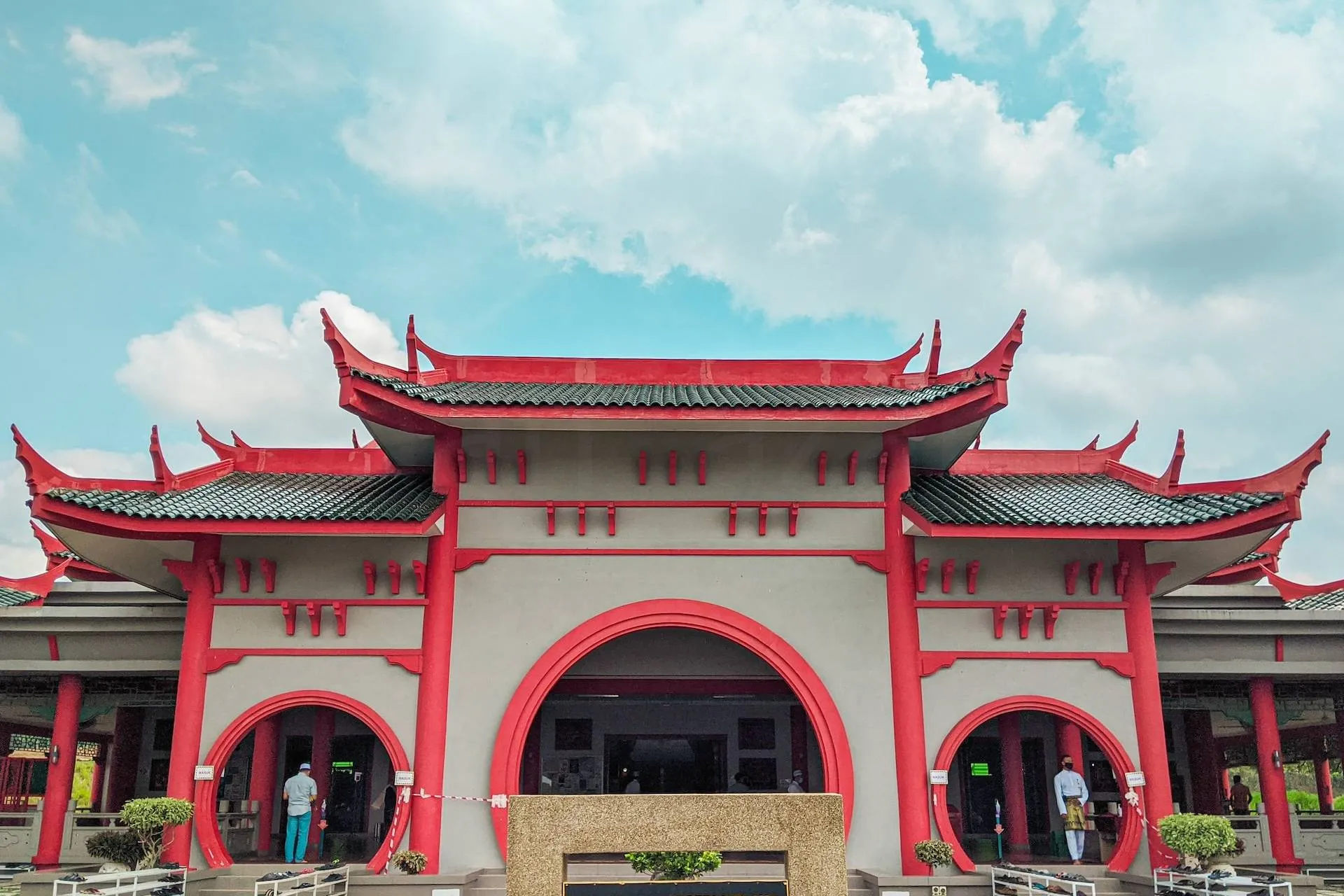 red and white concrete building under white clouds during daytime