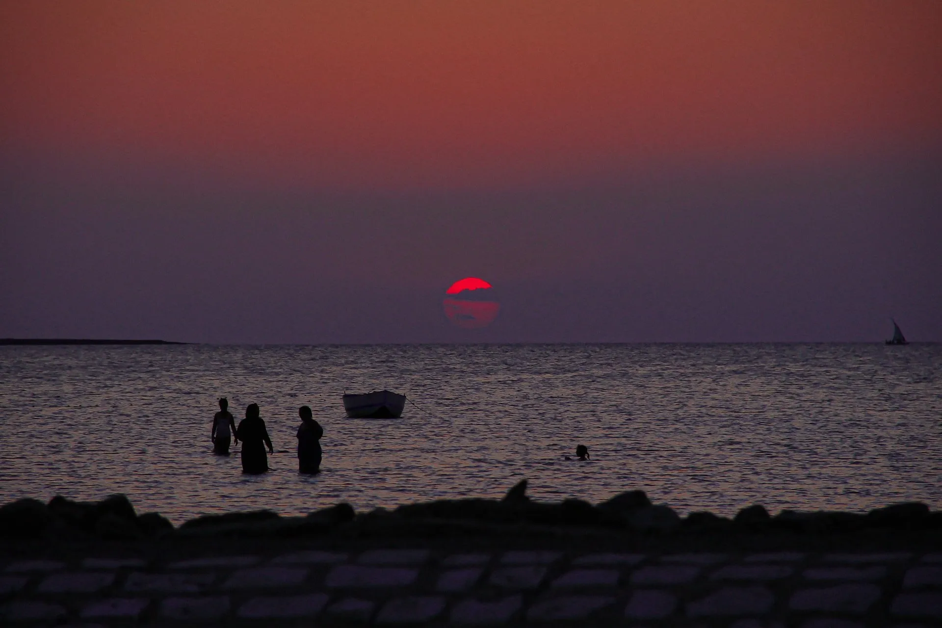 silhouette of people on beach during sunset