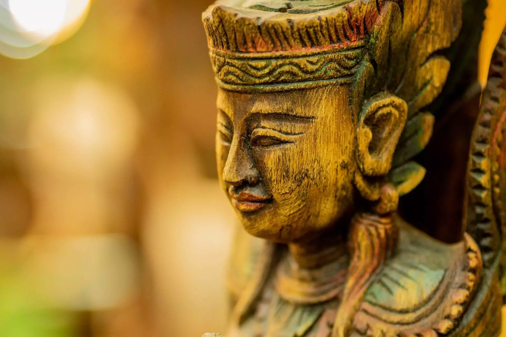 brown carved deity statue in selective focus photography