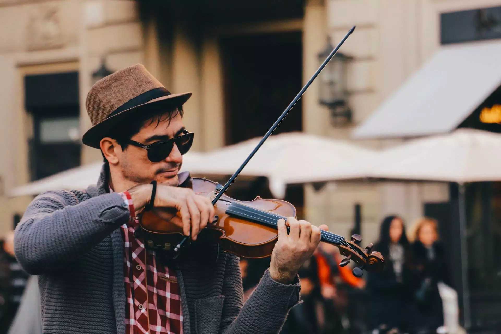 man in black and white long sleeve shirt playing violin