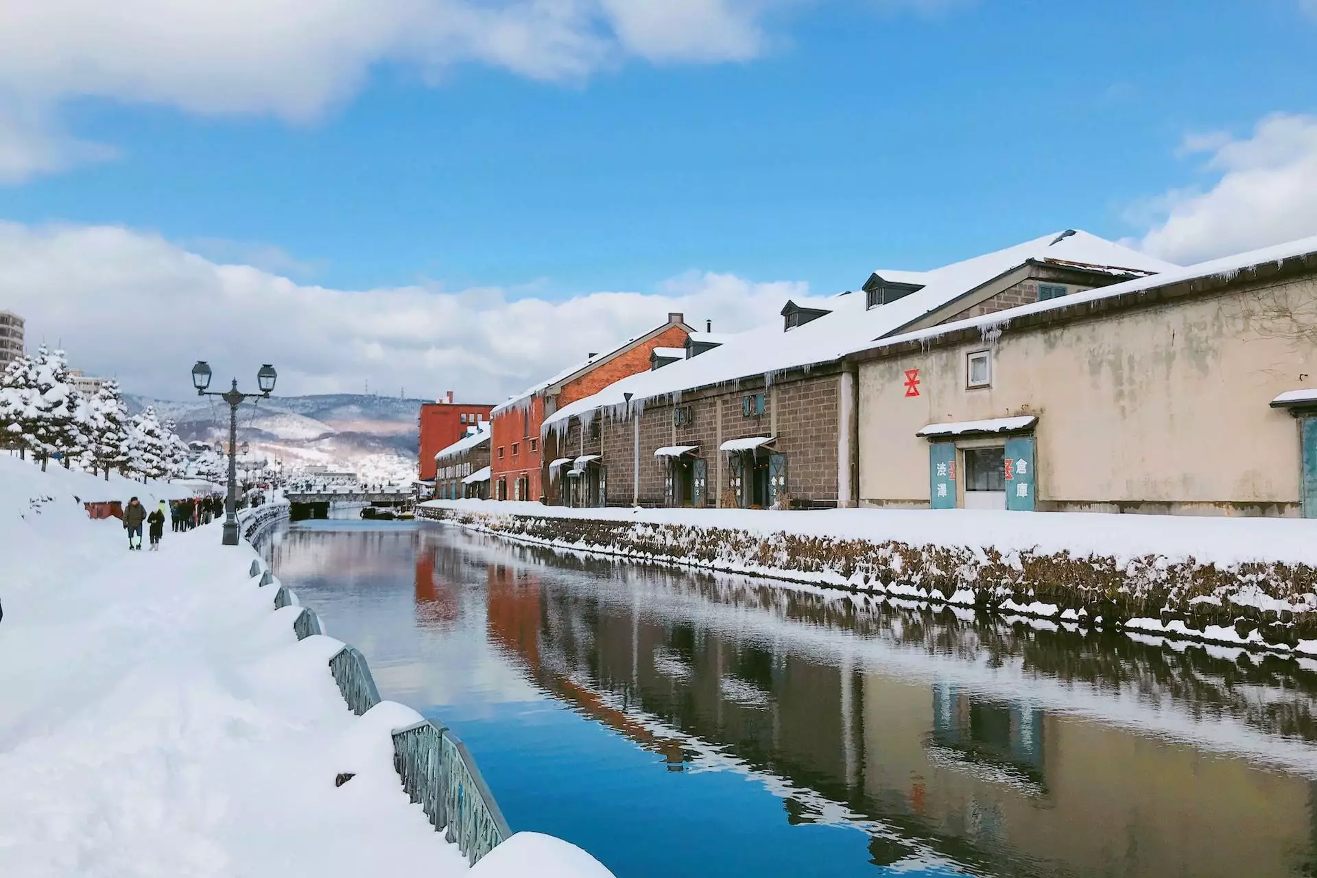 brown and white concrete building near body of water under blue sky during daytime