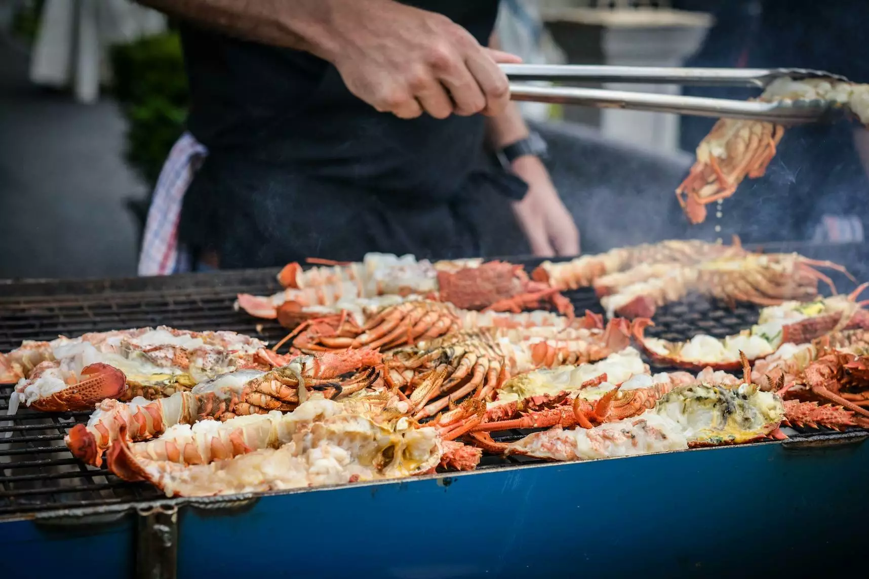 man grilling crabs during daytime