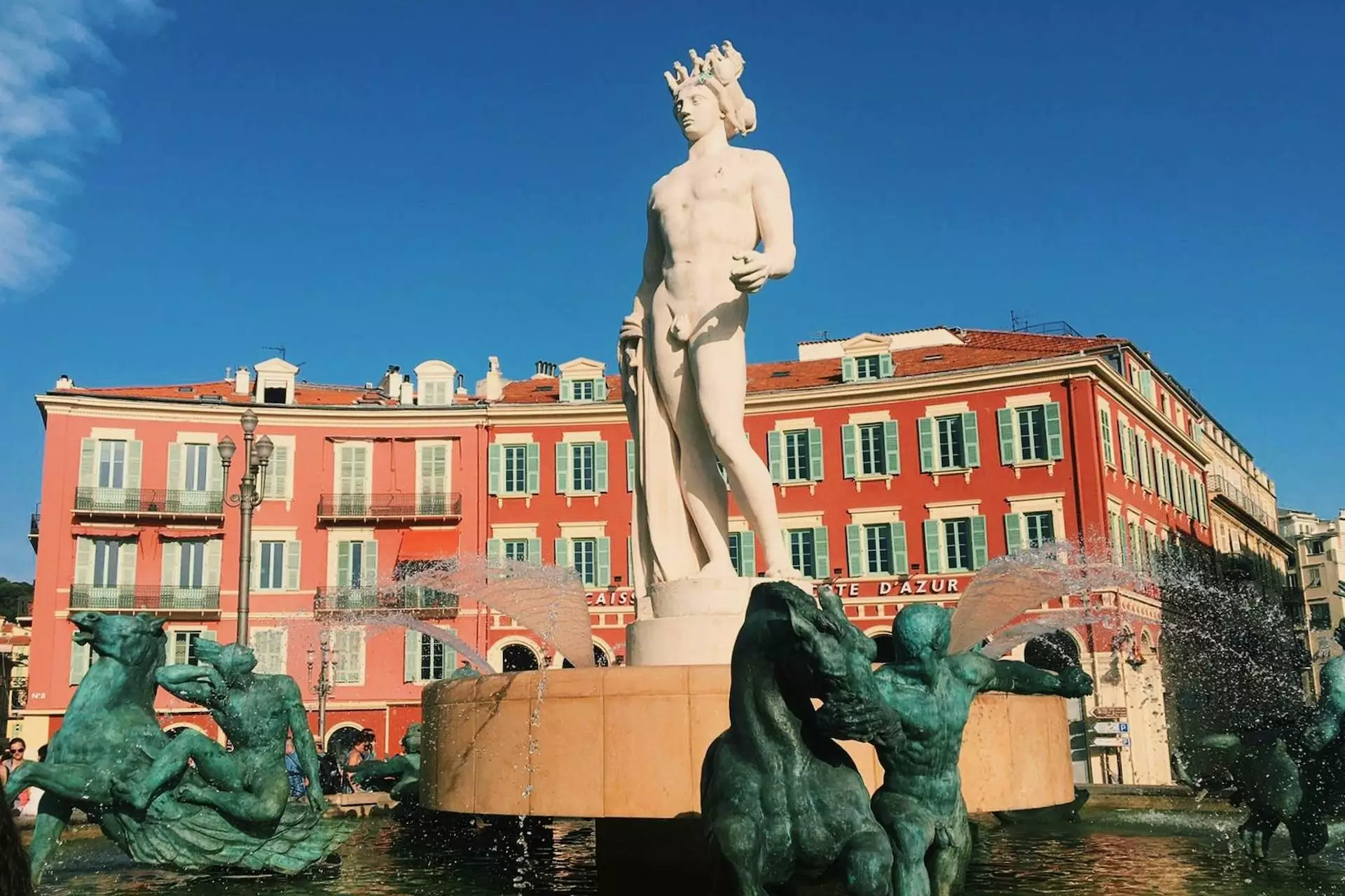 man statue near brown building during daytime